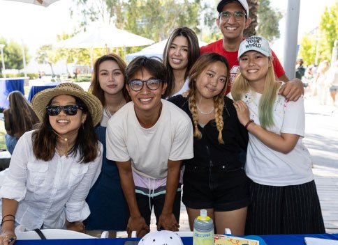students take a group selfie on campus
